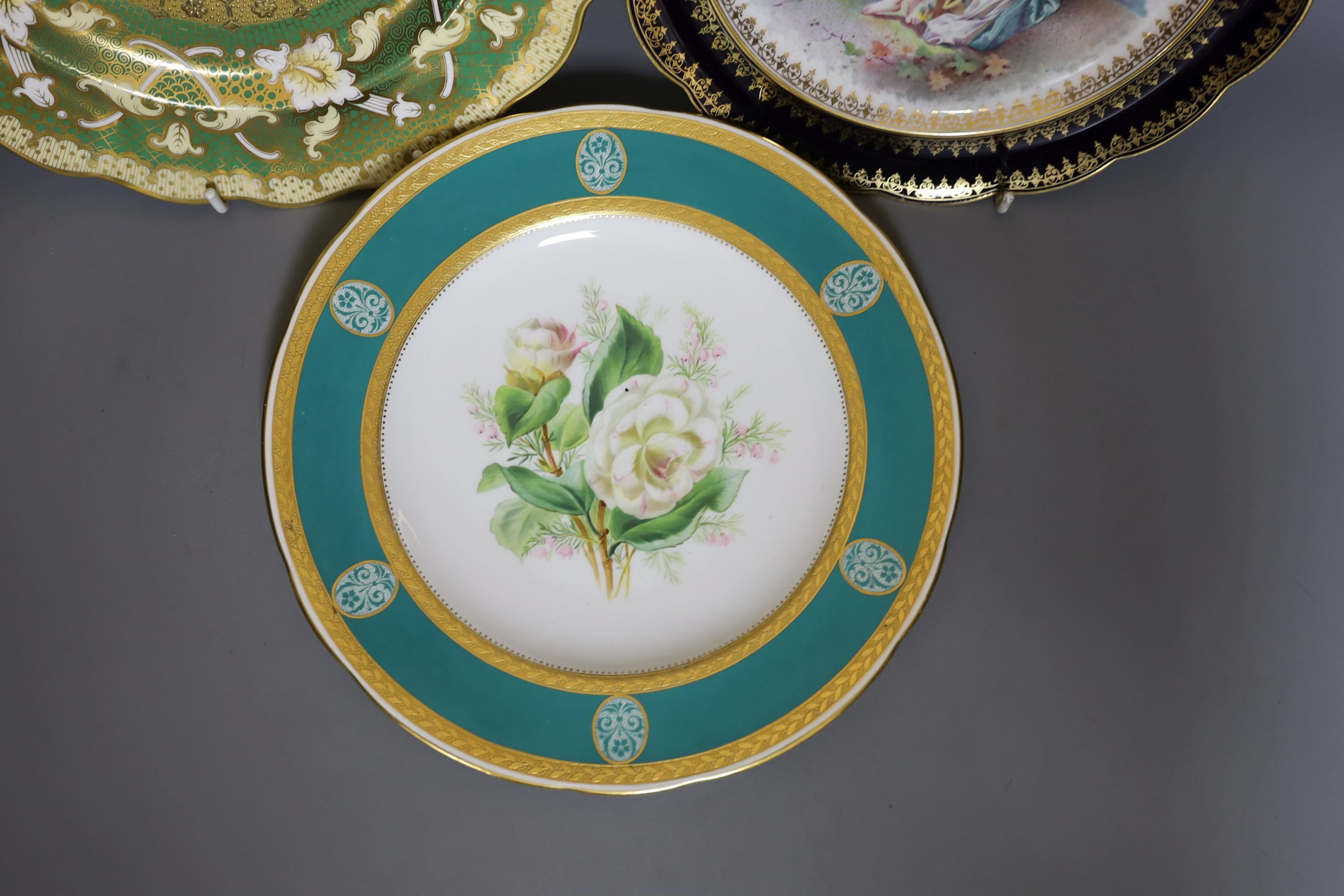 Two 19th century English porcelain flower painted plates, one by Minton and a continental porcelain plate painted with bathers by E Laurent (3)